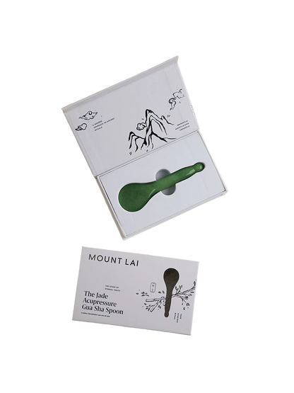 Green spoon with packaging on a beige background