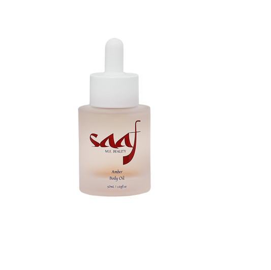 Sculpted bottle of saaf me beauty amber body oil on a white background
