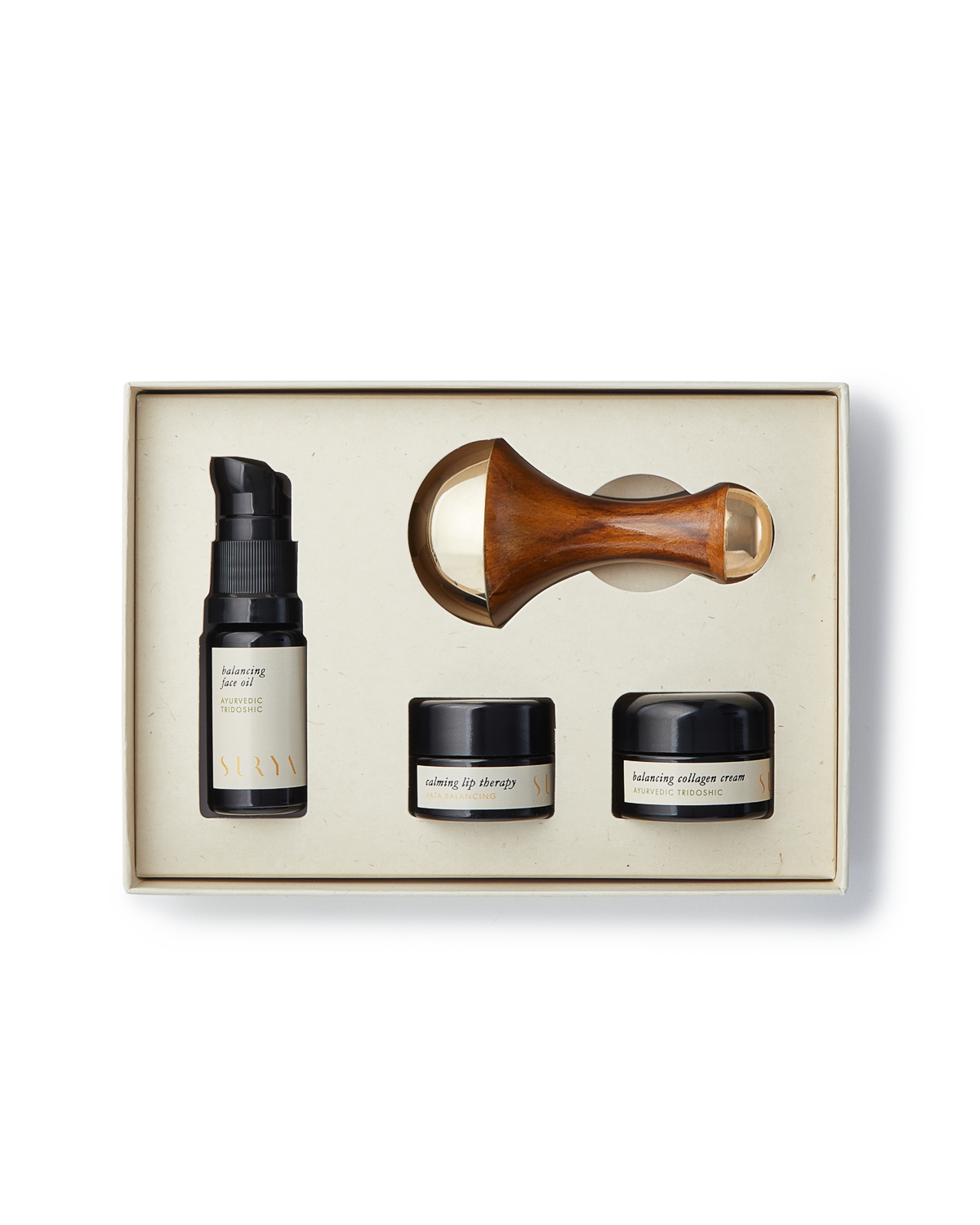 Skincare product set with bottles and a roller in a box on a white background